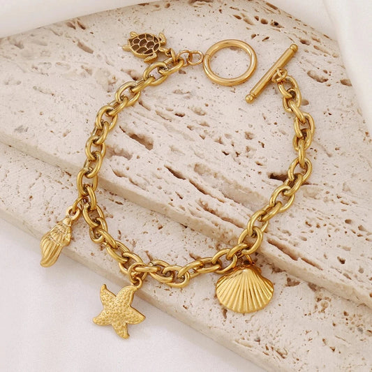 Bijoux Charm Bracelet charm avec étoile de mer doré à bascule.