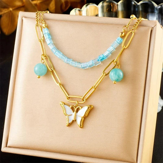 Bijoux Charm Collier à charm doré papillon blanc et perles bleues