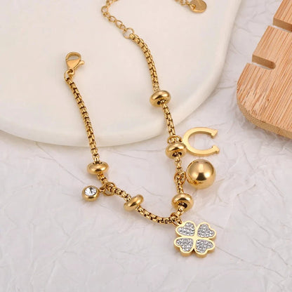 Bijoux Charm Bracelet en or avec charms et clips, orné d'un trèfle à 4 feuilles