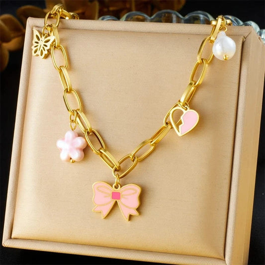 Bijoux Charm Collier à charms doré et nœud papillon rose