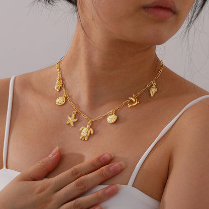 Bijoux Charm Collier doré à charms tortue de mer et coquillages